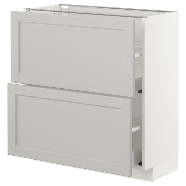 A white METOD kitchen cabinet with beveled edges. It a drawer and a door, both framed in solid birch with birch veneer panels.