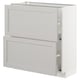 A white METOD kitchen cabinet with beveled edges. It a drawer and a door, both framed in solid birch with birch veneer panels.