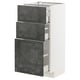 A white METOD kitchen cabinet with three dark grey kalhyttan drawers. It a sleek, modern design with a concrete effect finish.