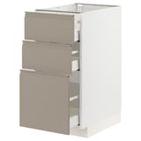 Ikea METOD kitchen cabinet. Three beige drawers with integrated handles. White frame, sleek design.
