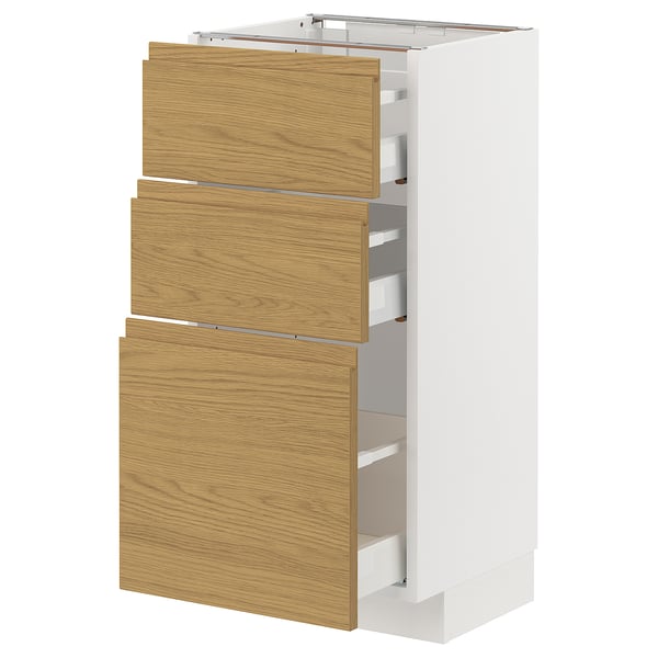 White METOD kitchen unit with three oak-effect drawers. Modern, minimalist design with integrated handles.