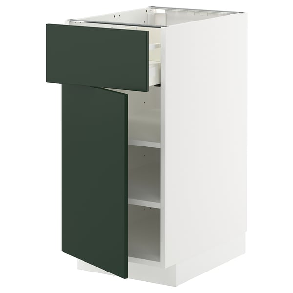 A white METOD cabinet with green havstorp drawer, partially open.