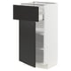A white METOD kitchen cabinet with a black drawer and door. The cabinet adjustable shelves and a modern design.