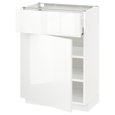 A high-gloss white METOD kitchen cabinet with glass doors and adjustable shelves. It has a sleek, modern look.