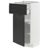 Modern white METOD kitchen cabinet with matte black drawer and door.