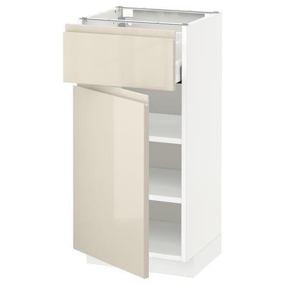 An IKEA METOD kitchen cabinet in high gloss beige with a handle-less design. It includes a drawer and a door on both sides.