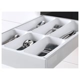 White kitchen drawer organizer; keeps utensils tidy and easily accessible.