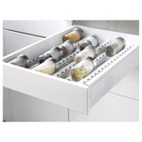 White kitchen drawer organizer holding multiple spice jars, part of the METOD system.