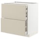 A white METOD kitchen cabinet with beige havstorp drawer fronts. It has two full-extension drawers with a smooth, clean look.