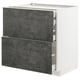 A modern, white METOD kitchen cabinet with dark grey concrete effect drawers, featuring a sleek, rectangular design.