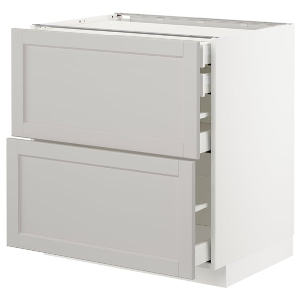 A white METOD kitchen cabinet with two drawers and a pull-out shelf.