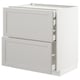 A white METOD kitchen cabinet with two drawers and a pull-out shelf.