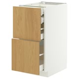 Ikea METOD cabinet in white and oak wood. Two wooden drawers, one open, on a white base.