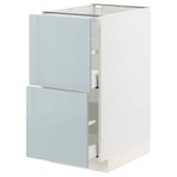 A white METOD kitchen cabinet with two light blue drawers and a pull-out shelf, made of particleboard and plastic.
