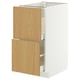 This image shows a white METOD cabinet with light wooden drawers and sleek design. Perfect for modern kitchens.