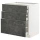 Dark grey folded drawers with white cabinet; modern kitchen storage.