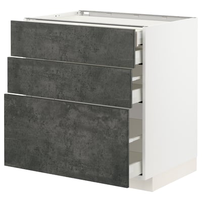 Dark grey folded drawers with white cabinet; modern kitchen storage.