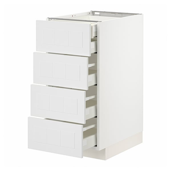 White METOD kitchen unit with four partially open drawers, sleek and modern design.