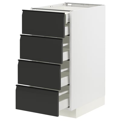 METOD kitchen unit in white with four matte black drawers, sleek handles, and modern design.