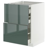 Modern kitchen cabinet in high-gloss grey-green with two open drawers on white base.