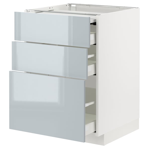 A white ikea METOD kitchen cabinet with grey-blue high-gloss drawers pulled out.