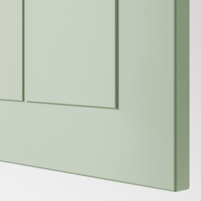 Green kitchen cabinet detail, showing sleek, smooth finish and sturdy construction.
