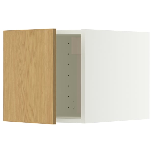A white kitchen cabinet with a wooden door. The door has hinges and is open, revealing the interior.