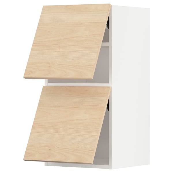Two light wooden kitchen cabinets with open doors, featuring light ash finish and silver handles.