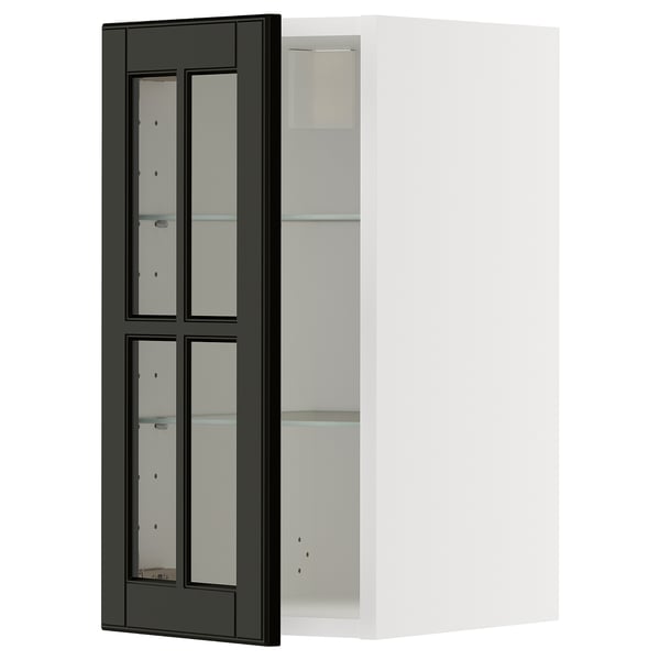 A black glass door cabinet from the METOD kitchen system. It has a sleek, modern design with beveled edges and a sturdy frame.