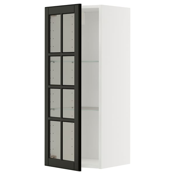 This image shows a white METOD wall cabinet with black glass doors, featuring a sleek and modern design.