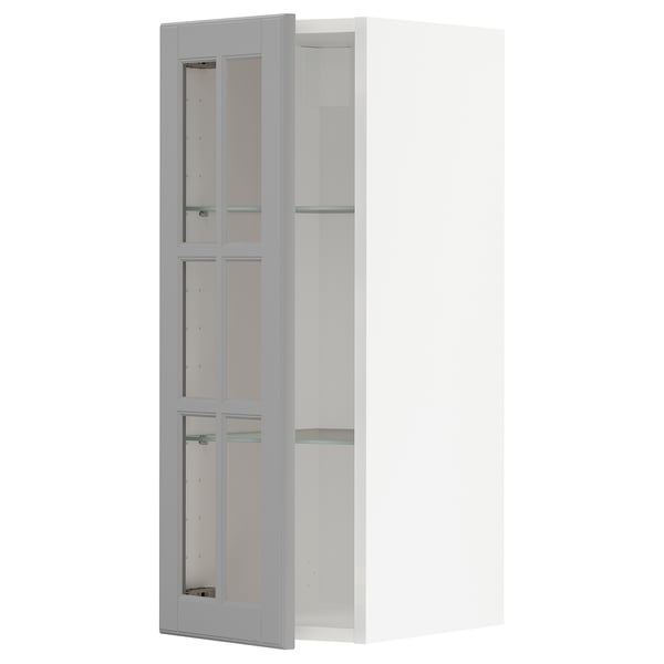 Open grey METOD kitchen cabinet with glass doors showcasing a modern design.