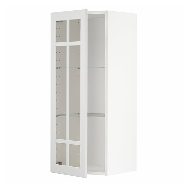 A white METOD kitchen cabinet with glass doors. It has a rectangular shape, four shelves, and is predominantly white with clear glass panels.