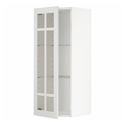 A white METOD kitchen cabinet with glass doors. It has a rectangular shape, four shelves, and is predominantly white with clear glass panels.