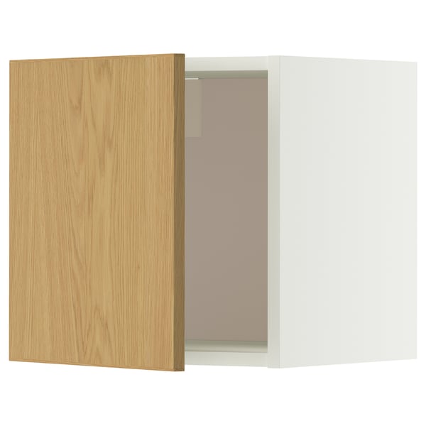 A white and light wooden METOD wall cabinet with one door slightly open, revealing glass shelves inside.