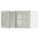 A green METOD kitchen cabinet with double glass doors, featuring a modern and crafted design.