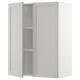 Light grey METOD kitchen cabinet with beveled edges and two open doors.