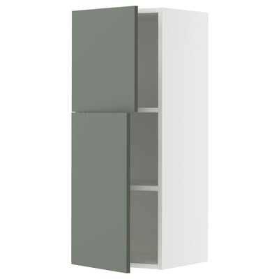 A modern, greenish-grey and white METOD kitchen cabinet with two adjustable shelves.