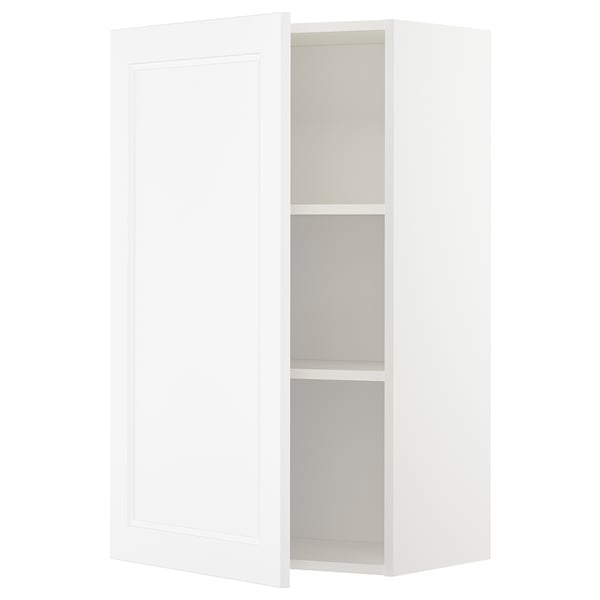 A white METOD kitchen cabinet with a door and adjustable shelf. Its rectangular and a simple, modern design.