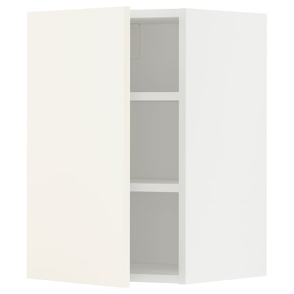 A white METOD wall cabinet from ikea with three shelves. Its rectangular and has a simple, modern design.