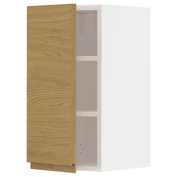 A wooden cabinet with a light oak finish and minimal design. It has three empty compartments and is part of the METOD kitchen system.