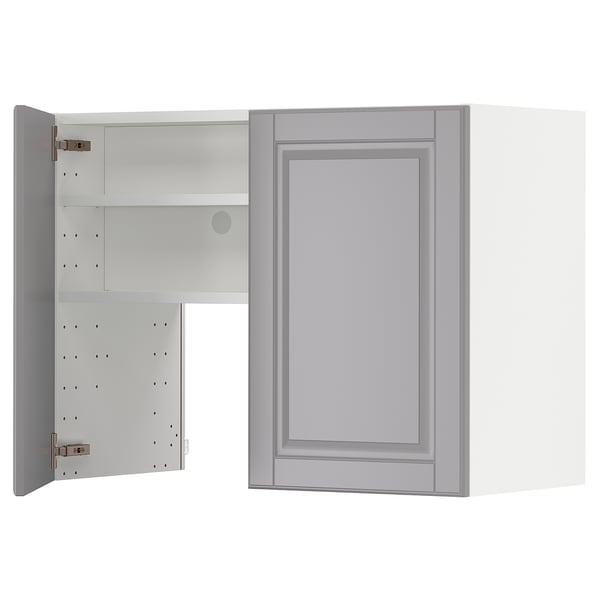 A light grey METOD kitchen cabinet with a traditional bevelled edge design. It opens to reveal two adjustable shelves.