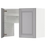 A light grey METOD kitchen cabinet with a traditional bevelled edge design. It opens to reveal two adjustable shelves.