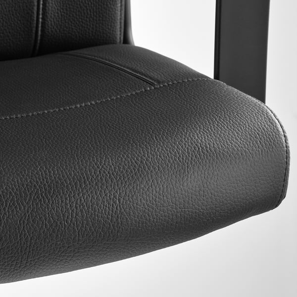 Close-up of a high-quality, black office chairs padded armrest, showcasing its textured fabric and sturdy design.