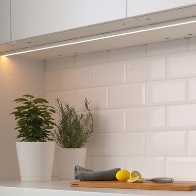 Kitchen with led under-cabinet lights, plants, lemons.