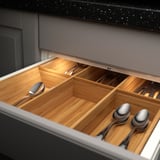 Drawer with led lights showing cutlery compartments.