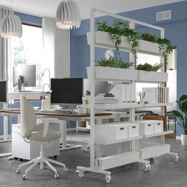 Modern workspace with MITTZON mobile plant stand, desk, chairs, computers, and lamps.