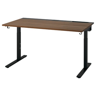 The MITTZON sit-stand desk with a wooden top and black legs, designed for adjustable height.