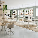 Modern office with MITTZON dividers. Beige shelves on wheels, green walls, and plants. Lighting and neutral desk setup.