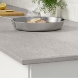 A kitchen counter with a frying pan containing food. The counter is heat and scratch-resistant, easy to clean, and very hygienic.