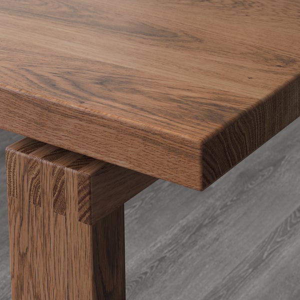 Close-up of well-crafted wooden table with smooth, natural finish and sturdy joint.